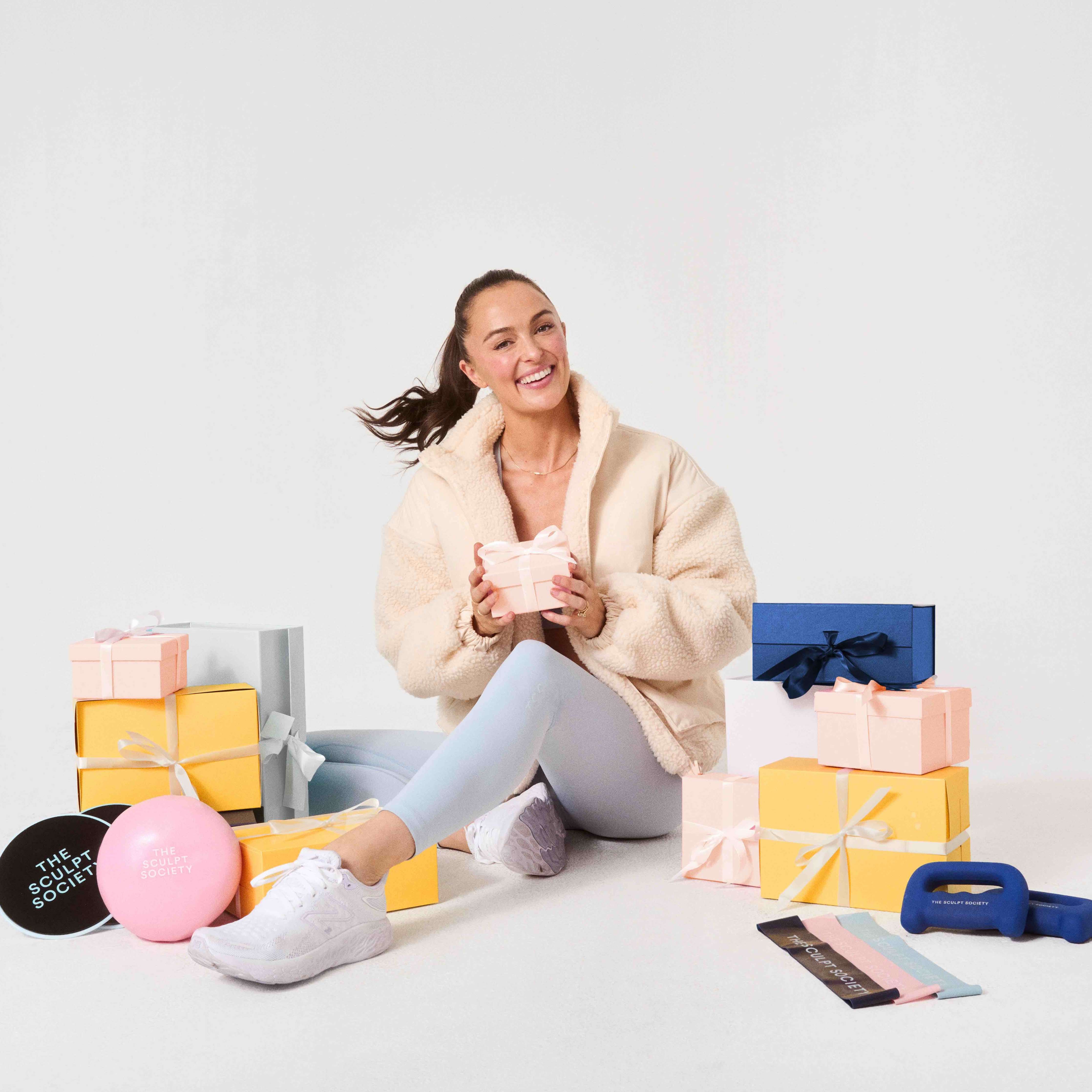 Woman sitting surrounded by gifts