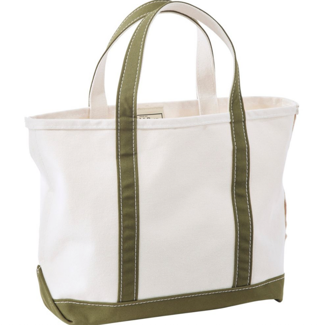White tote bag with green straps on a white background
