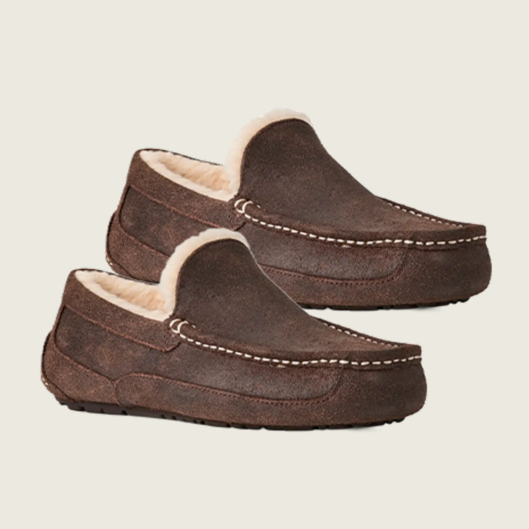 Pair of brown slippers with fur lining on a white background